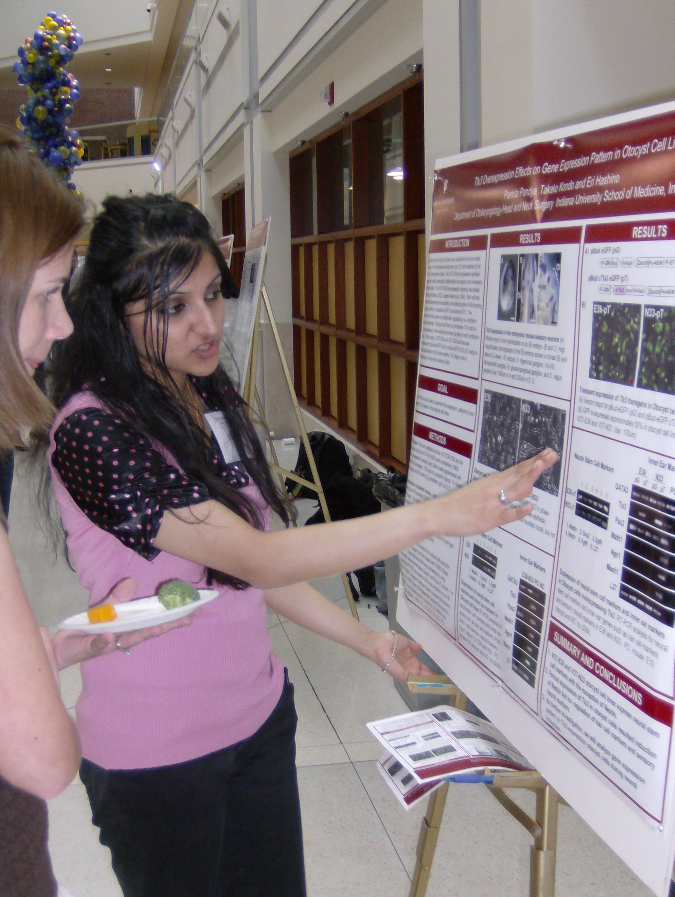 Intern presenting a poster of her internship work.